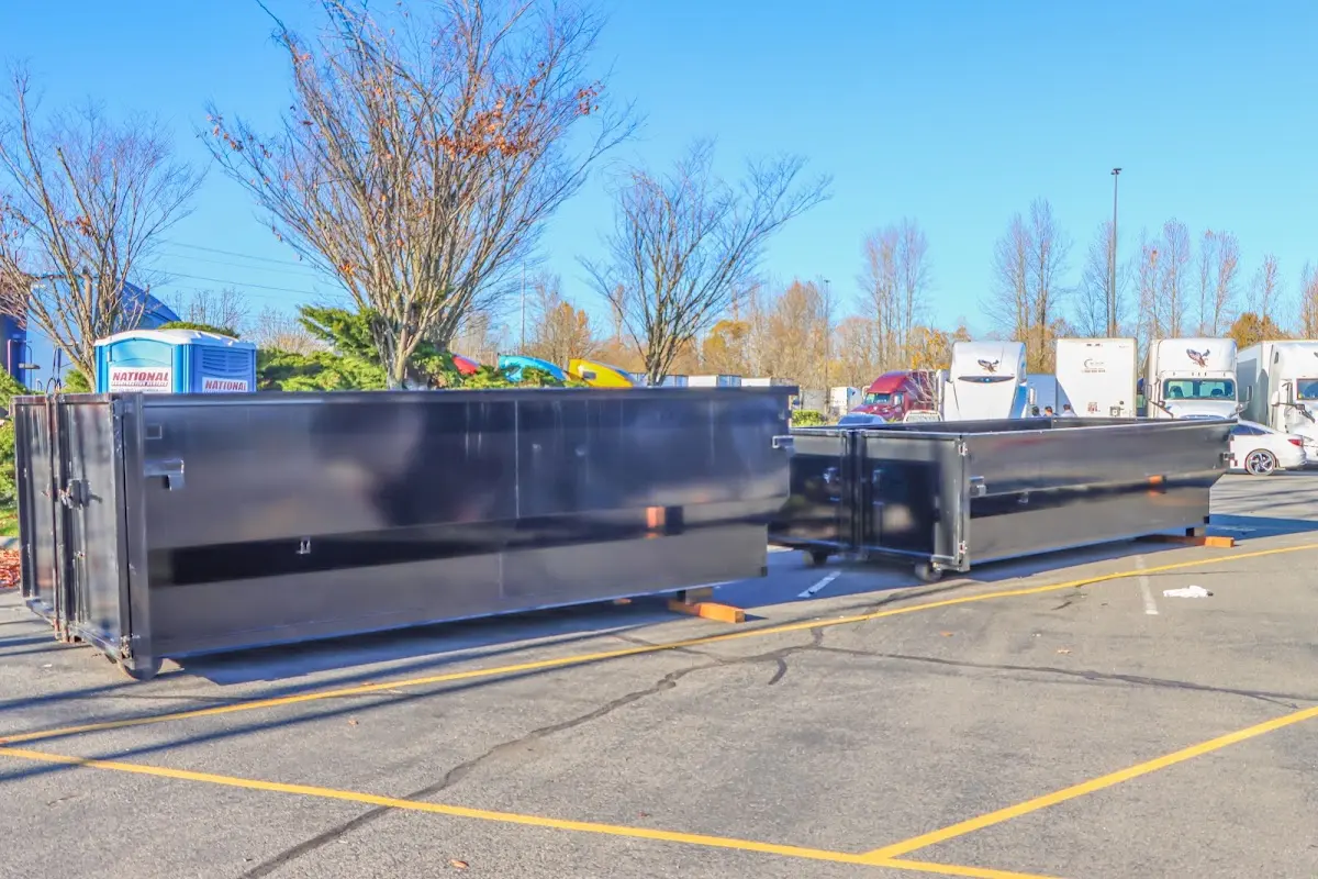 Professional dumpster rental service with roll-off container on residential driveway in South Whittier